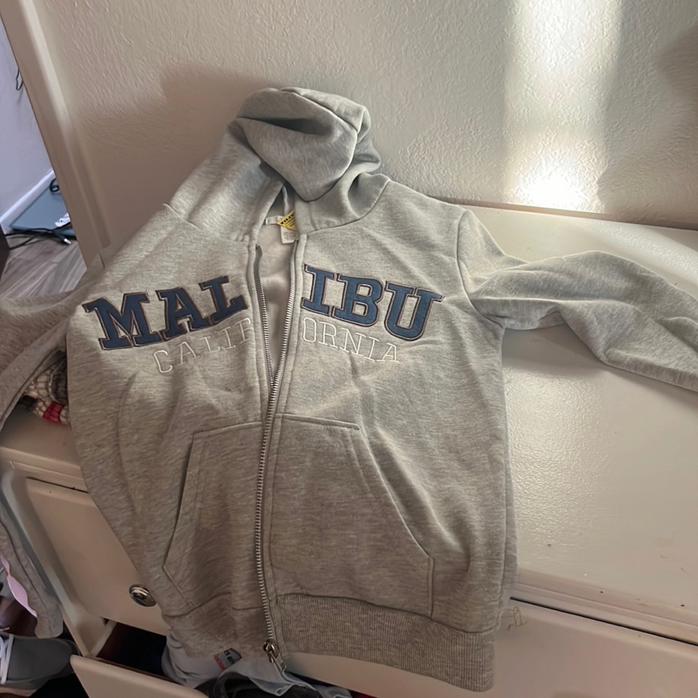 Grey Tilly brand zip up hoodie. Size medium. Brand new tags still on.